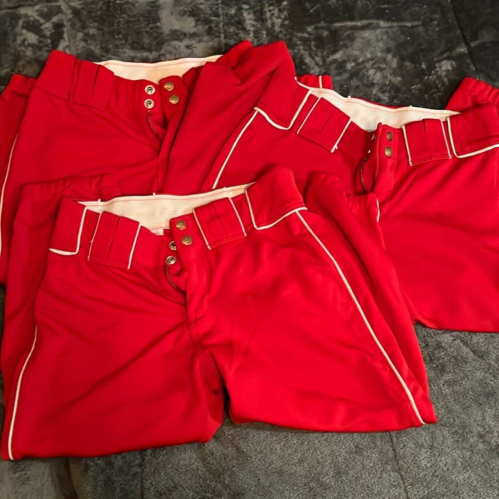 Women’s red Boombah softball pants, white stripe down sides